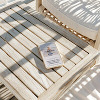 Mobile view of the Coastal Dream one-page website template on a sunlit wooden table