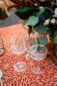 champagne coupe and wine glasses on velvet table cloth