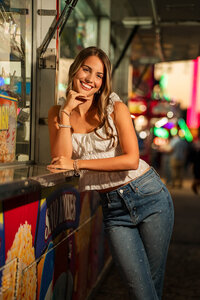 Senior portrait at the Greater Gulf State Fair in Mobile, Alabama — smiling with her arms resting
on a fried Oreo and funnel cake stand.