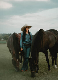 Senior portrait at Triple T Farms in Fruitdale, Alabama — standing with two horses in a field,
looking off into the distance.