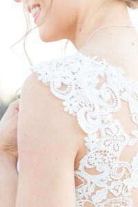 Lace detailing of bride's lace gown on shoulder