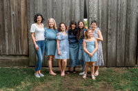 Grandmother with daughters and granddaughters standing together at family farm in New Bern North Carolina