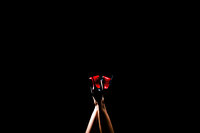 Luxury Boudoir Portraits by Moving Mountains Photography in NC - Photo of a woman's red heels in the air.