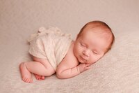 Newborn baby wrapped in neutral tones with army dad during an omakase studio portrait session