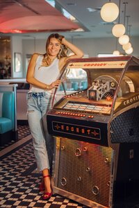 Senior portrait at Sunliner Diner in Gulf Shores, Alabama — leaning against the jukebox and
laughing.