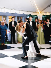 A cinematic capture of a couple’s first dance under a waterfront tent, preserving the atmosphere and emotion of a coastal wedding weekend.