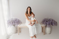 Charleston Mini Sessions - Mother embraces her baby during Mother's Day Mini Session at Holy City Babies in Charleston, SC.