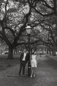 couple standing at street light during their engagement photos in atlanta GA