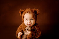 6 months old baby boy photoshoot in cleveland ohio holding a stuffed bear