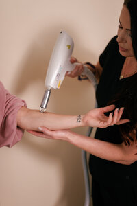 Medspa practitioner providing treatment on a patient's arm