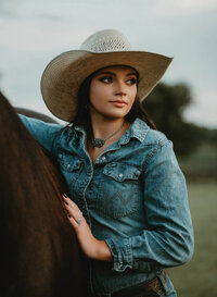 Senior portrait at Triple T Farms in Fruitdale, Alabama — close-up holding her horse’s mane,
looking off into the distance.