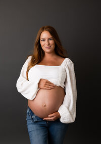 Session of expecting mother on gray backdrop