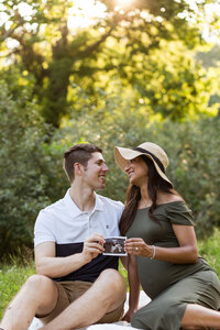 Man and woman posing for maternity photography in Sterling Heights MI