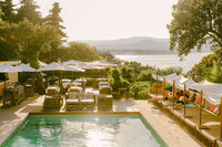 Sunset over the pool terrace and dining cabanas at Bastide d'Antoine in Saint-Tropez, luxury hotel photography by Chelsea Loren