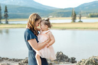 Mom cuddling her toddler during an outdoor family session in Central Oregon