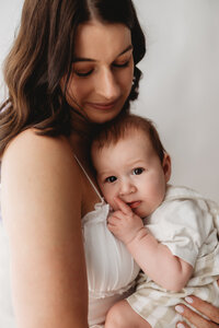 Charleston Mini Sessions - Mother embraces her baby during Mother's Day Mini Session at Holy City Babies in Charleston, SC.
