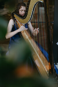 close up of harpist playing during wedding ceremony