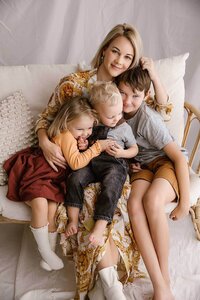 a family of four hugging during a photography session with aimee kelly photography in new plymouth taranaki