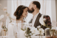 Groom kissing bride at micro-wedding in Maison Charlottesville. Amy Mitchell Photography.