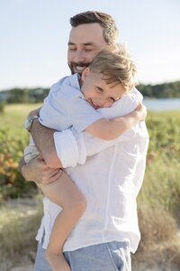 A coastal New England family session with toes in the sand and salty snuggles by the water's edge. North Shore Family Photographer. Deborah Zoe Photography.