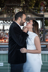Future bride and groom at their engagement photoshoot on a rooftop bar. They are dressed classy in black and white. Photo by Phavy Photography, Georgia engagement photographer
