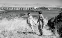 Grooms hand in hand before their wedding at the Sunshine Mill Winery. Taking portraits in front of the Dalles Dam.