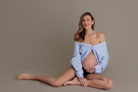 pregnant woman sitting gracefully during studio maternity portrait in North Hollywood