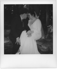black and white polaroid of bride and groom cuddling with their foreheads together