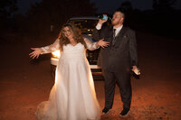 Bride and groom illuminated by car headlights at their Sedona elopement