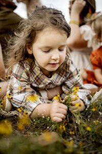 girl picks wildflowers in Grapevine Texas