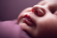 Close-up photo of a newborn’s lips and nose, showing delicate skin texture and softness, taken during a newborn session in Waukesha, WI for clients from Brookfield and beyond.