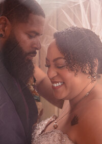 Bride and Groom laughing together under wedding veil atfter their wedding the Troutdale House by the Sandy River