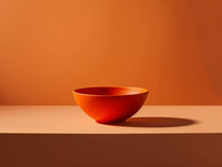 Elegant Red-Orange Bowl on Smooth Surface 092124