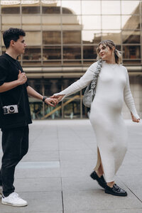 Modern and chic motherhood portrait of a mom-to-be in Prague streets - moody cinematic photography by Lucie Muse