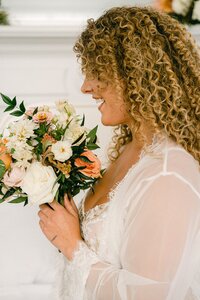 Bridal bouquet with peach roses, white lisianthus, and trailing greenery by Flowergirl Cville, Charlottesville florist | Photo by Lyn Waldrop Photography