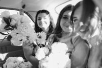 Candid bridal party photography in a classic car during a wedding in Christchurch