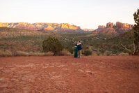 Couple standing together in the red rock desert landscape during their adventure elopement
