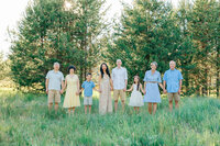 Family standing together in the woods during an outdoor portrait session in Bend, Oregon.