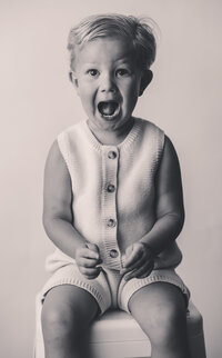 Little boy laughs at the camera during Personality Portrait Session in Charleston, SC.
