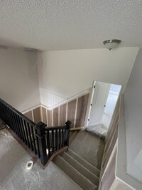 Staircase with Wainscoting getting prepped for painting in Wayzata.