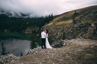 couple eloping cliff side in jasper / jasper elopement packages