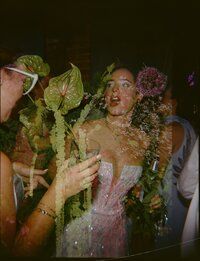 A double film exposure of a bride dancing with her guests at a wedding overlapped with tropical florals shot on 120 film.