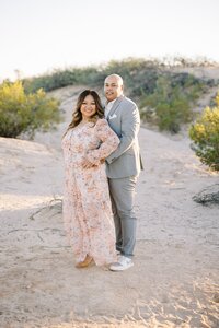 The Collins parents posing together in the Las Vegas desert during golden hour, sharing a warm and elegant moment in a natural outdoor family photography session.