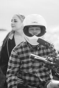 fashion couple sitting on motorcycle engagement photos on pacifica beach