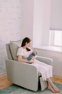 mom rocking newborn baby