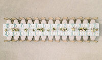 Symmetrical aerial photograph of a long, luxury outdoor reception table with pastel floral arrangements at Chateau de Tourreau in France.
