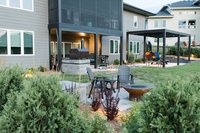 Waukee, Iowa back yard landscape with pergola, patio, fire pit and outdoor kitchen
