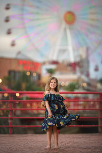 Young girl in dress standing near colorful lights in Eastern North Carolina