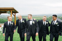 groomsmen-having-fun-company-stables