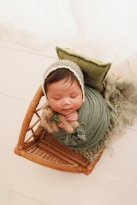 Neutral newborn photography with a hint of dusty blue, creating a soft and elegant baby portrait in Sacramento studio